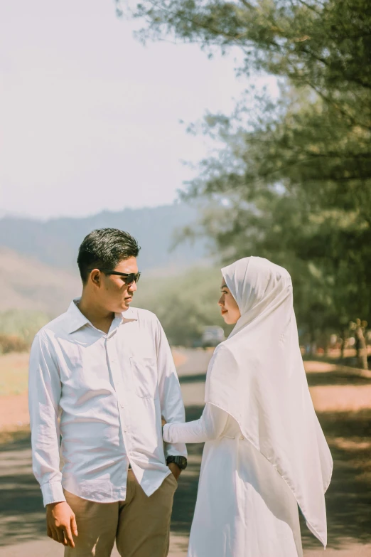 a man and woman walking on a path