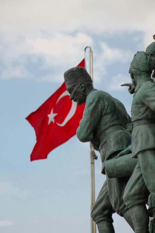 two soldiers with a red flag in the background