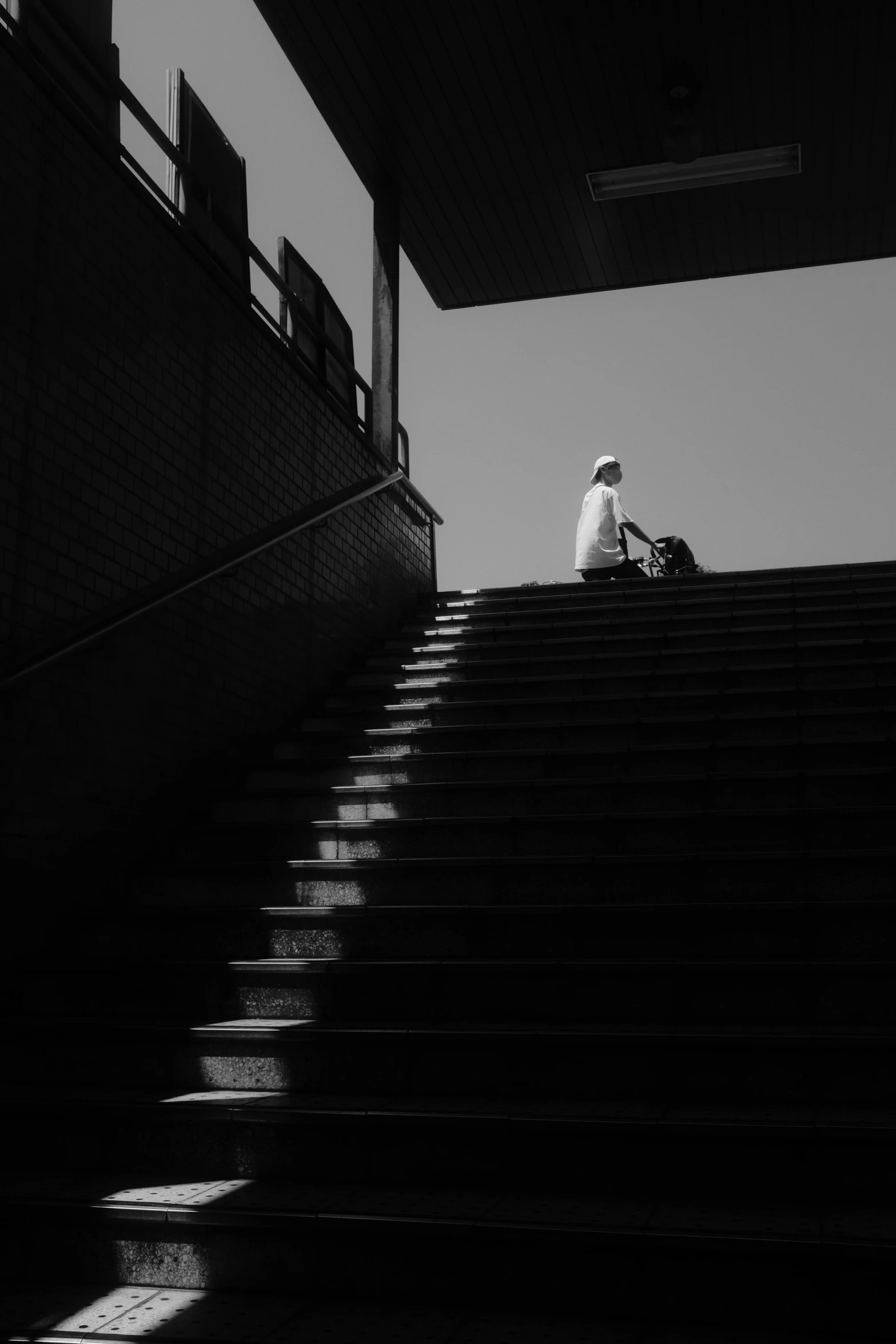 an islamic man sitting on the steps next to some stairs