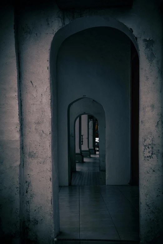 a narrow room with an archway and a fire hydrant in it