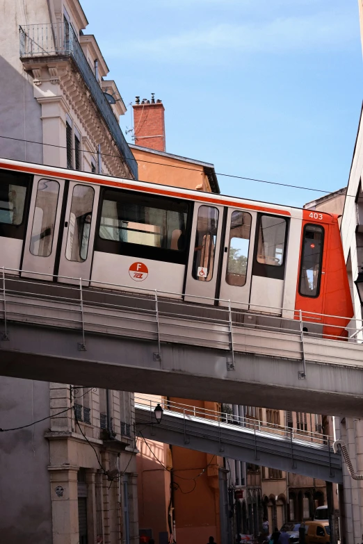 a subway train traveling down tracks next to buildings