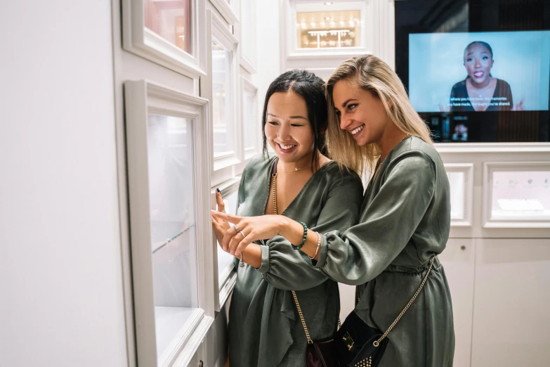 two women looking at soing on a display