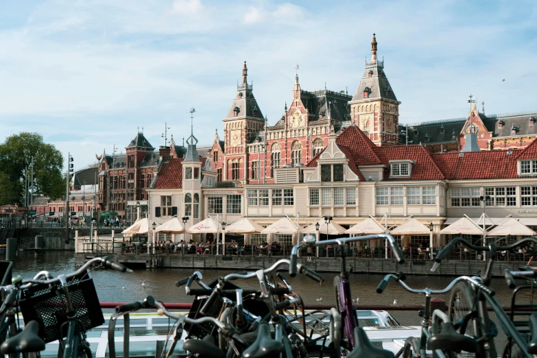 bicycle racks with bicycles and umbrellas against an old style building