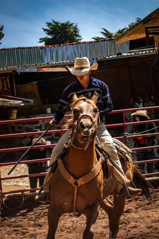 a man in a cowboy hat rides a horse