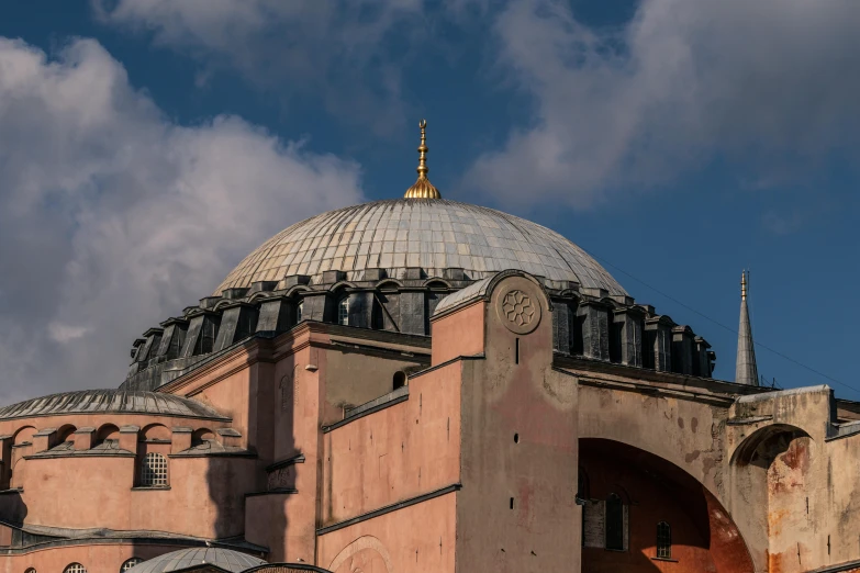 a large pink building with a domed dome on top