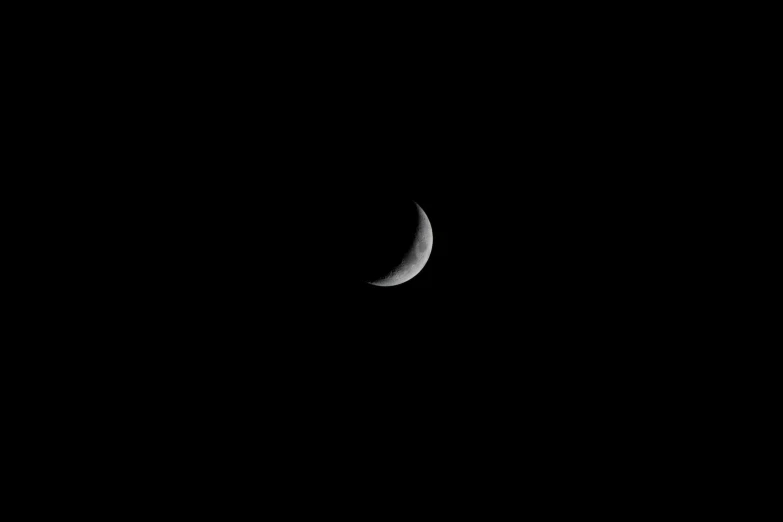 a crescented moon with a black sky background