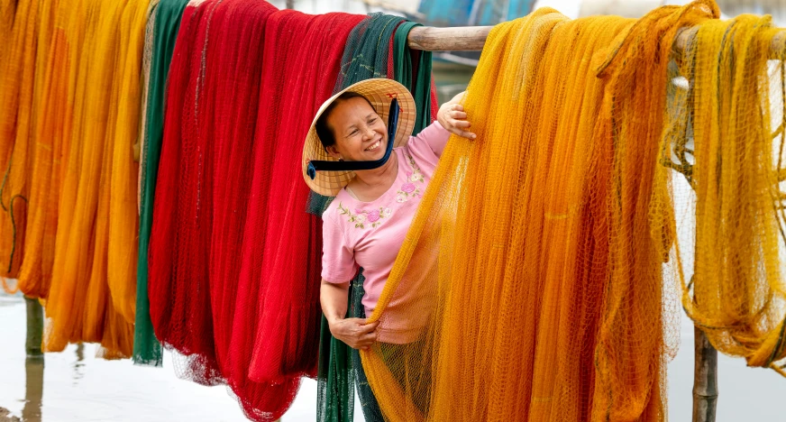 a woman in pink shirt hanging out with orange strings