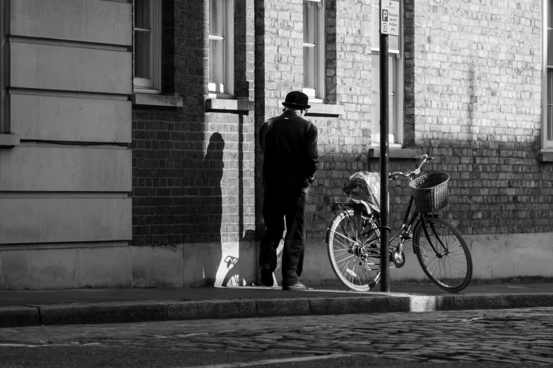 the person is looking at his bike on the street