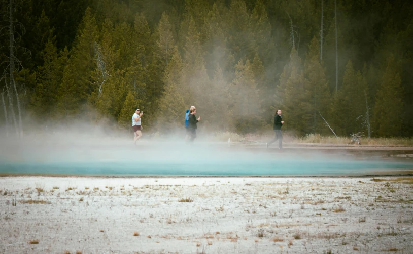 three people standing outside of a geoglyizing area