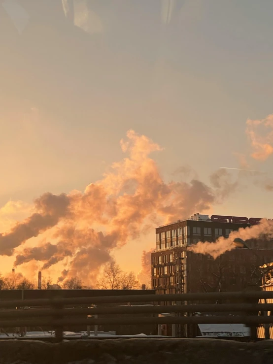 factory smokes in the background of a building