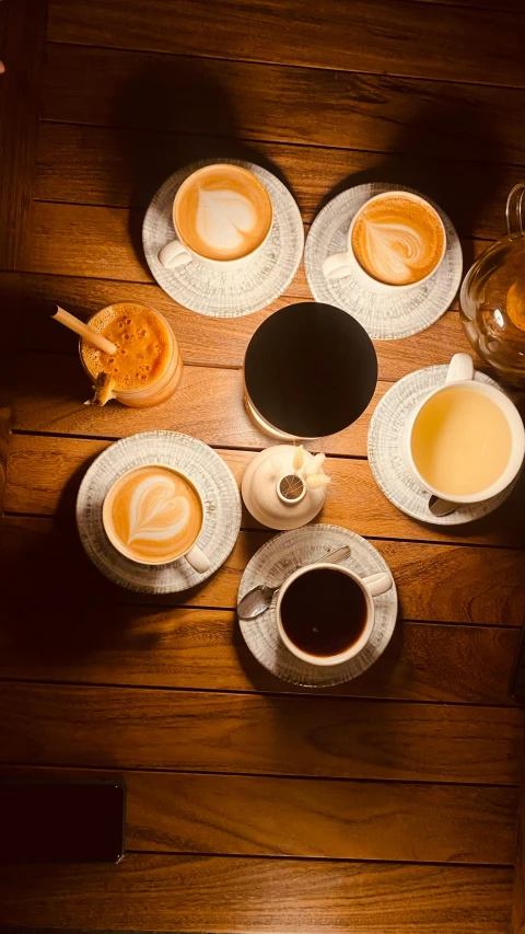 two cups of coffee sit on top of some saucers