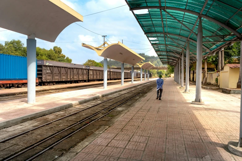 a man is walking toward the train tracks