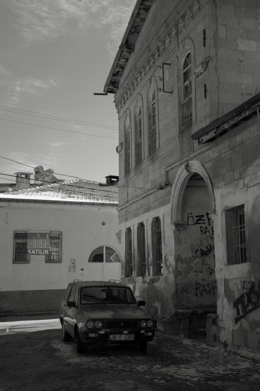 an old stone building has graffiti on it