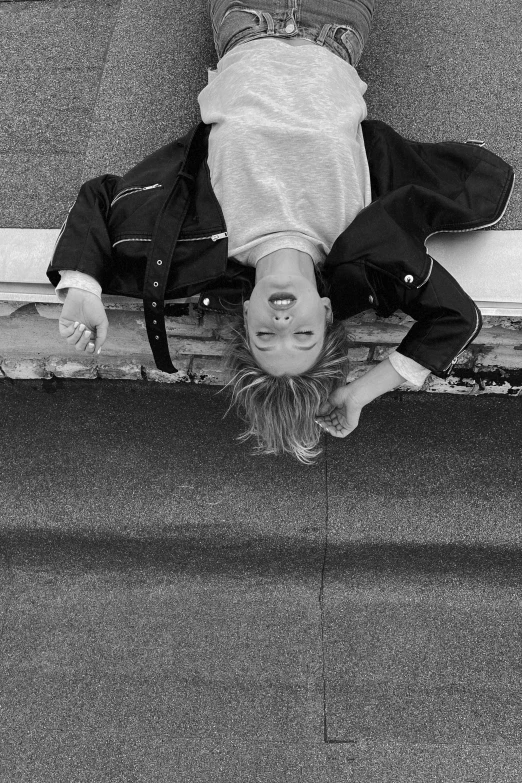 a person standing on a skateboard looking up at the ground