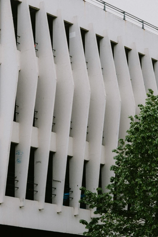 a tall building next to a tree in front of it