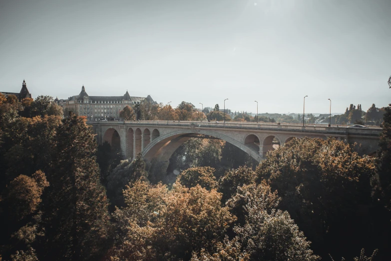 an old bridge over a wide river in europe