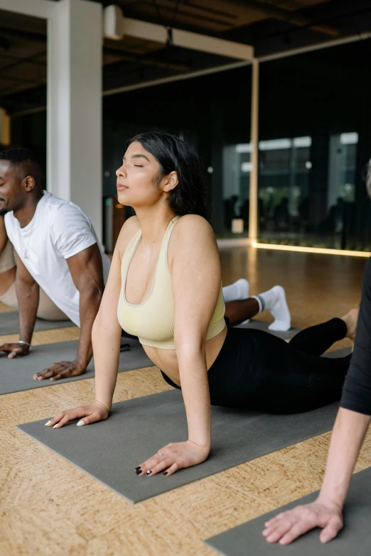 a group of people doing yoga in a gym