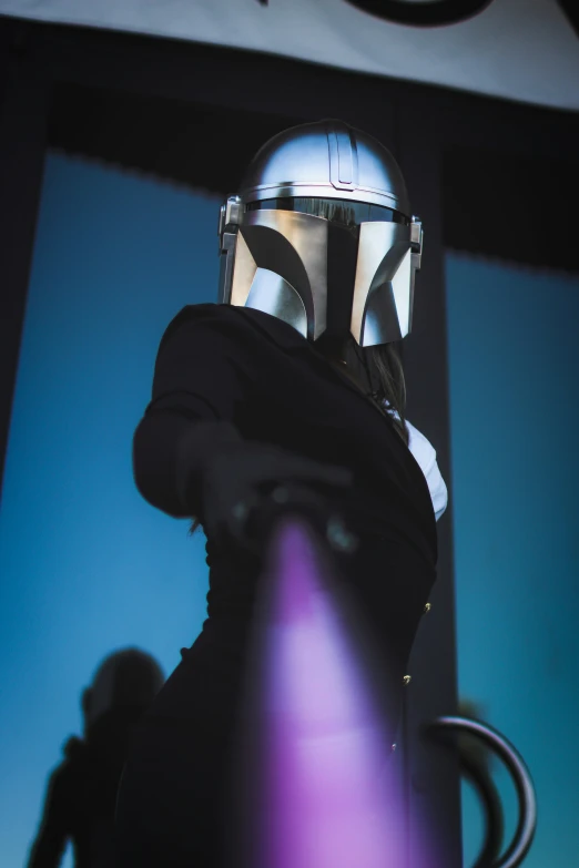 a star wars statue wearing a helmet with a microphone in the foreground