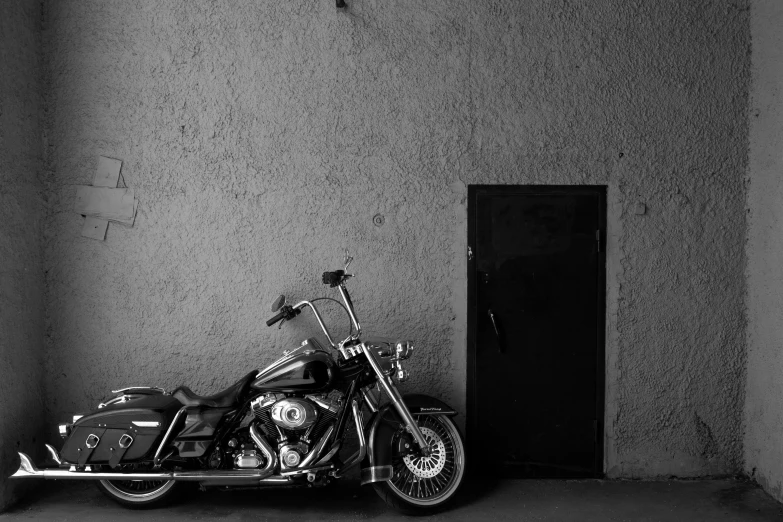 a motorcycle is parked against the wall in an empty room