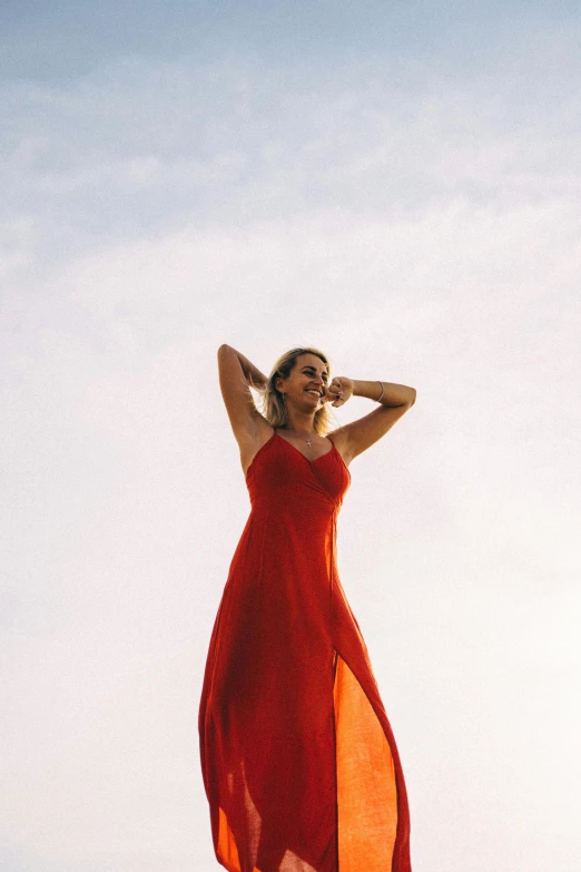 a woman wearing a long red dress