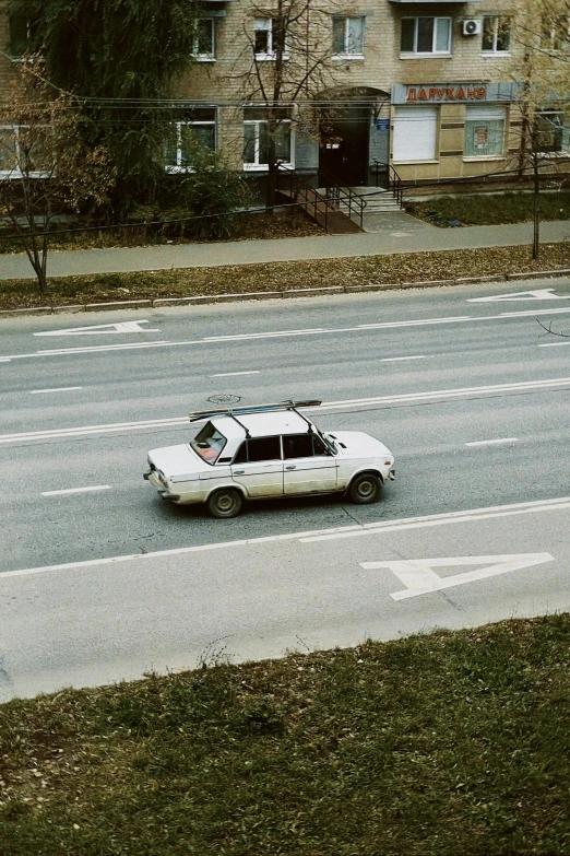 a white car with dots on it is traveling down a road