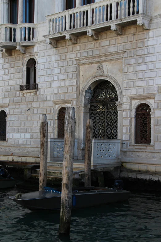 a boat with two smaller one parked in front of a building