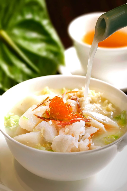 a white bowl filled with food and a green drink