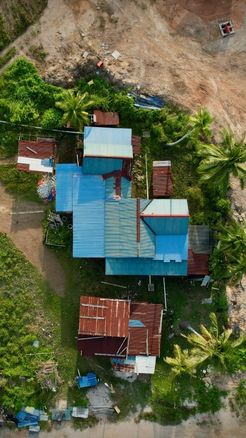 an aerial view of several colorful metal buildings