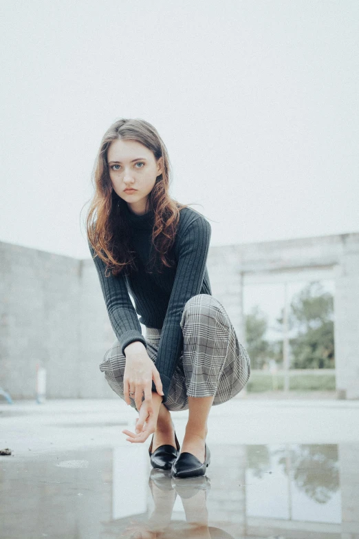 a young woman leaning on a table