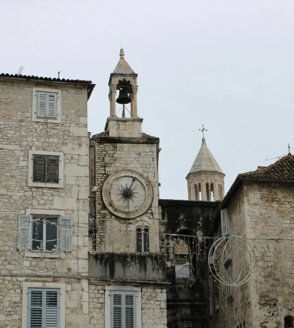 a clock tower in front of some buildings