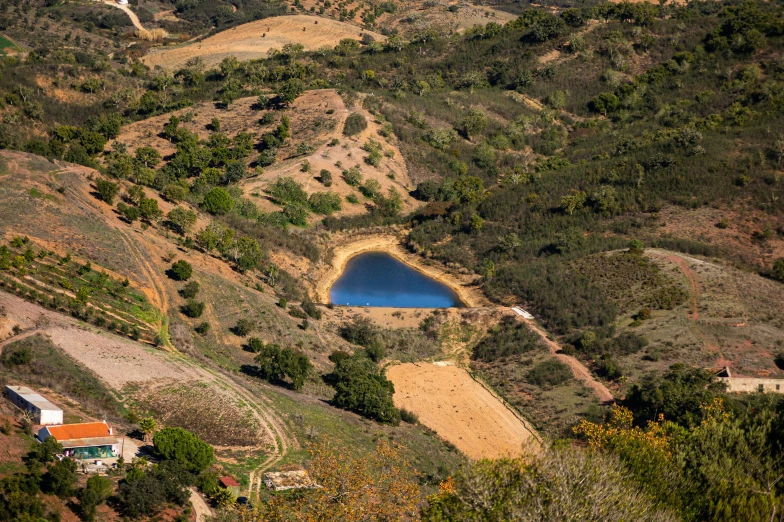 a very large blue lake surrounded by grass