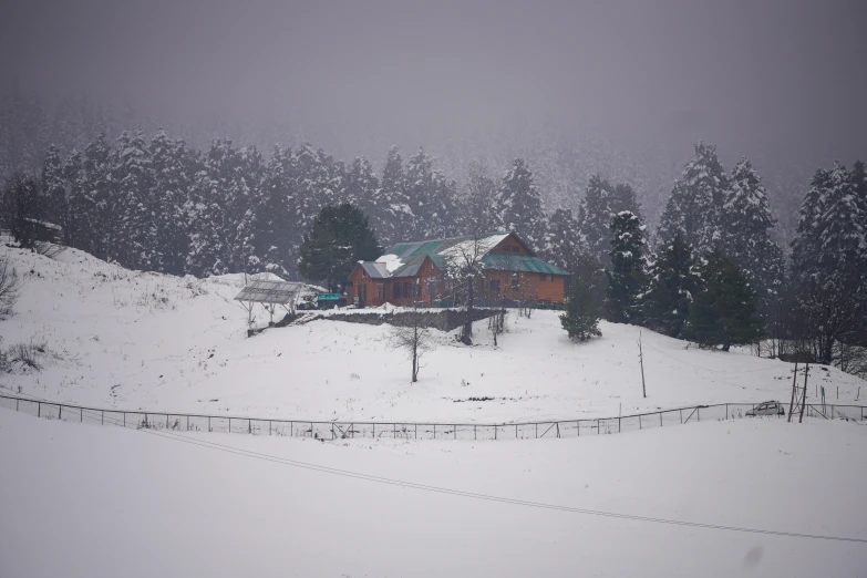 a small cabin in the mountains covered by snow