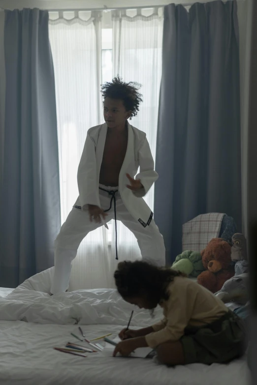 two children in a bedroom playing on a bed