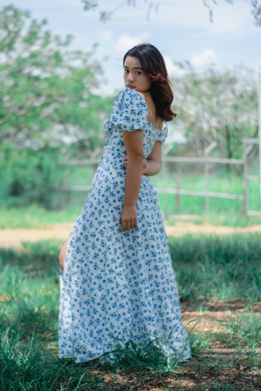 an older woman is standing in the grass