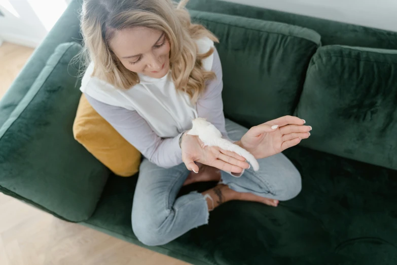 woman sitting on a couch with a broken arm