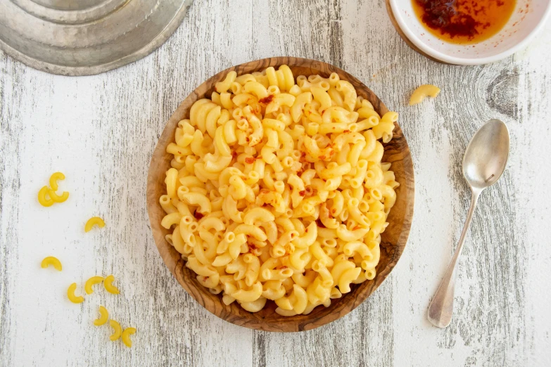 a bowl of macaroni on top of a white table