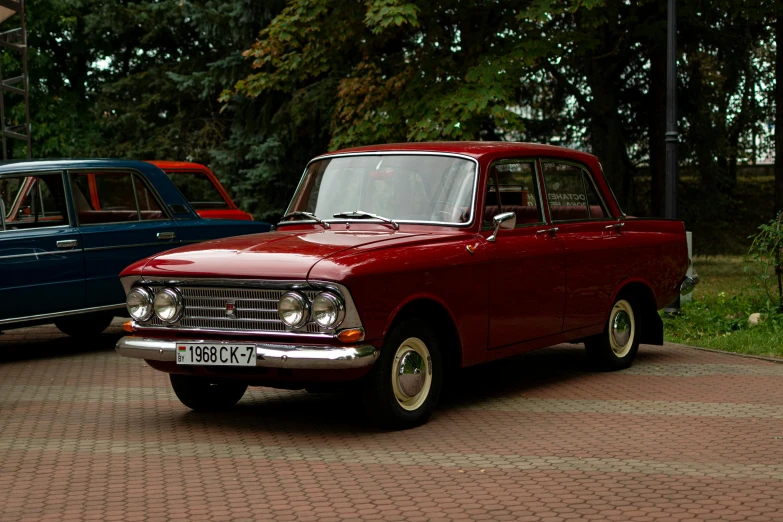 two old style cars parked side by side