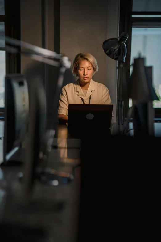 man at computer working in a dark room