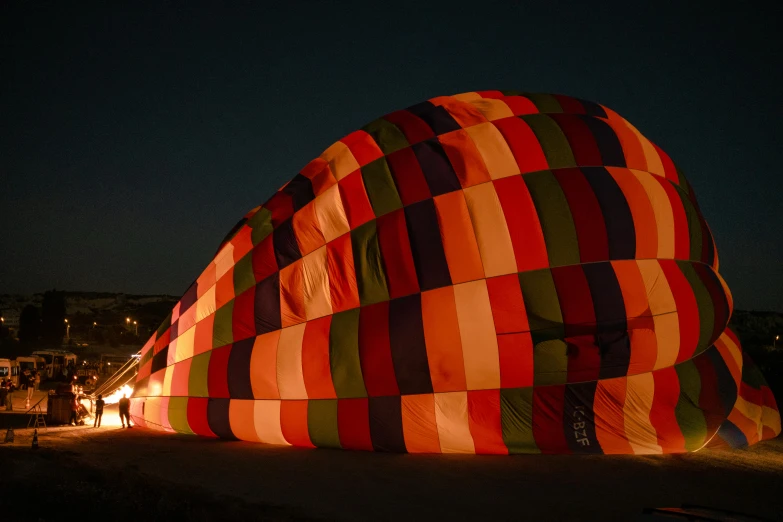 many people standing around looking at a large balloon