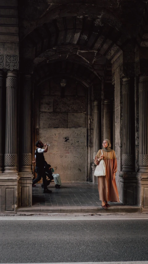 a woman is walking by a big building