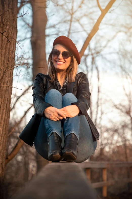 a girl sitting on the side of a swing