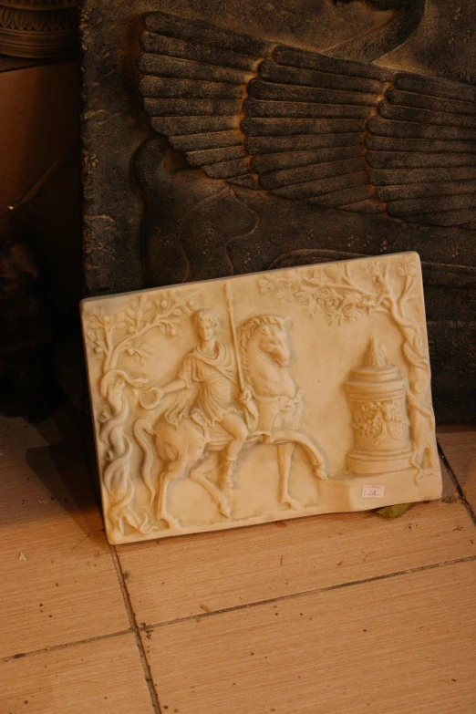 a small plaque with a horse and carriage next to it