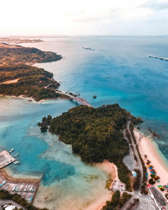 an aerial view of a beach with white sand and blue water