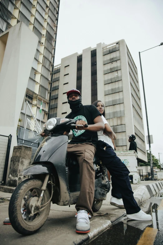 two young people are sitting on a motorcycle