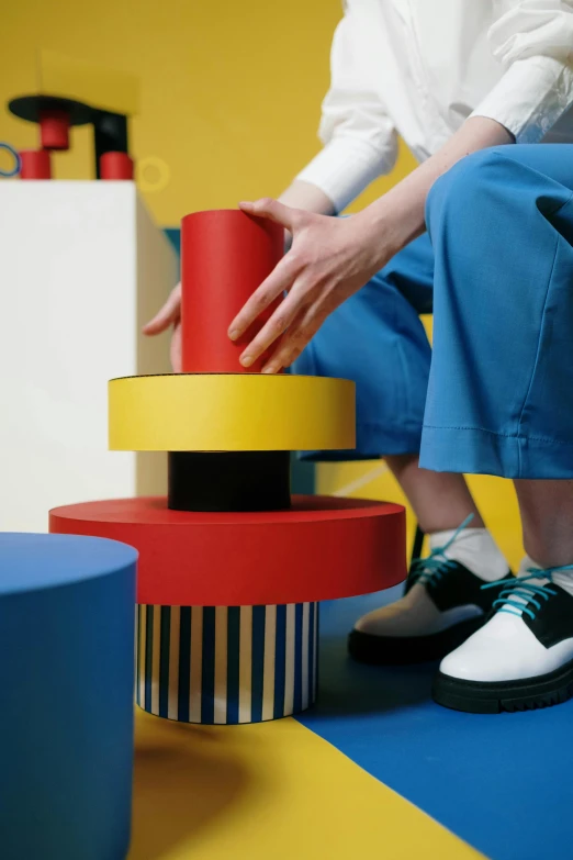 a person arranging stacked items on the floor