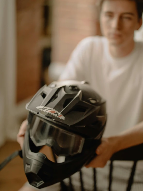 a man holding a helmet in his hand