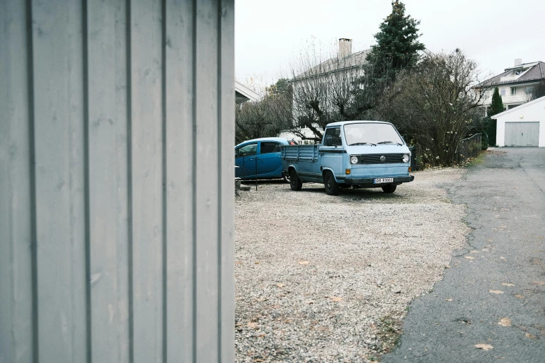 an old blue van and some older green vans