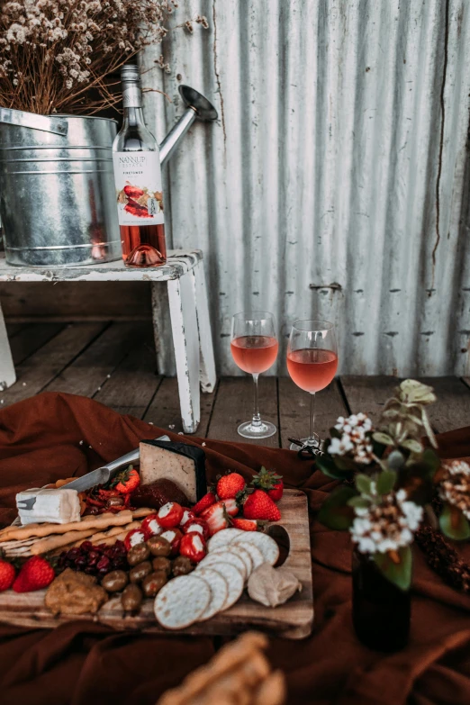 two glasses and a board with some food on it