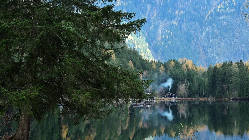 a very scenic mountain lake with trees near by