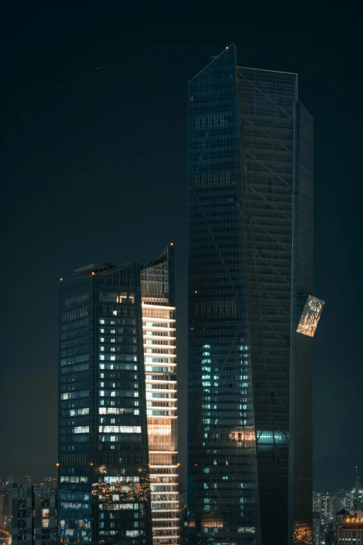 some very tall buildings in the night time